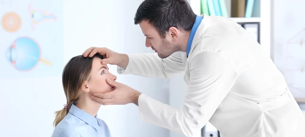 adult male doctor examining patient