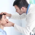 adult male doctor examining patient