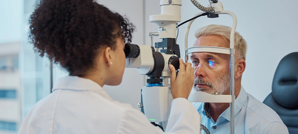 vision, eye exam and healthcare with a doctor woman or optometrist testing the eyes of a man patient in a clinic