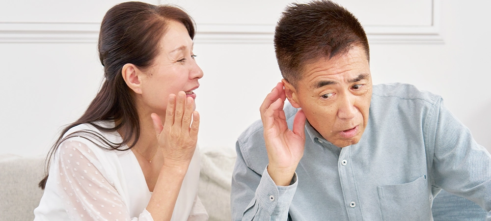 Asian senior man with hearing loss