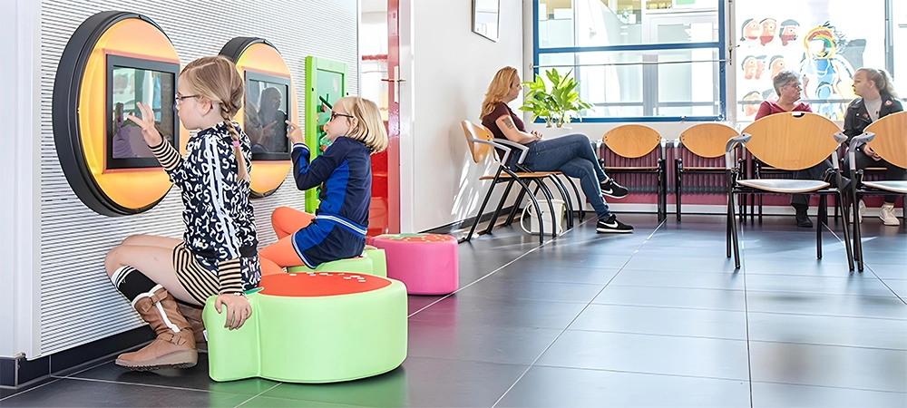 Children playing in a kid-friendly waiting area of a pediatric eye care clinic.