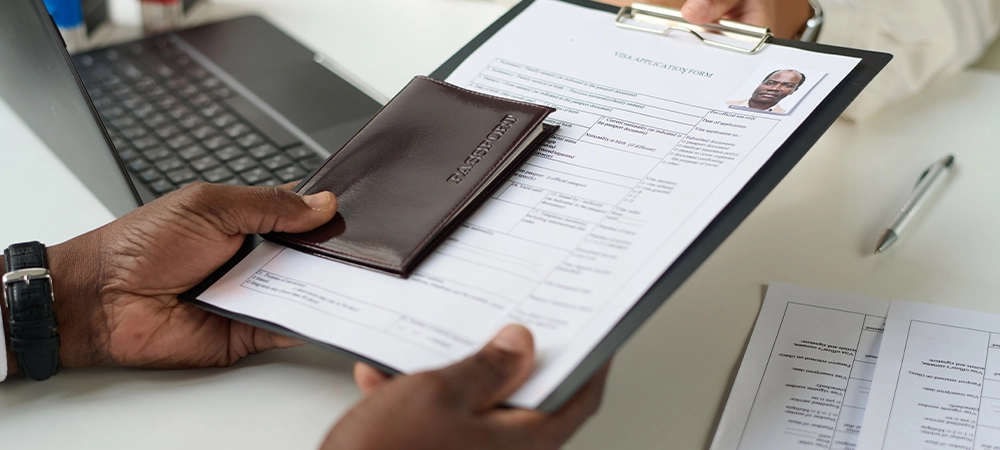 Smiling little girl shaking hand to positive man doctor pediatrician after successful checkup in medical clinic with parents sitting around. Medicare for kids and family doctor concept