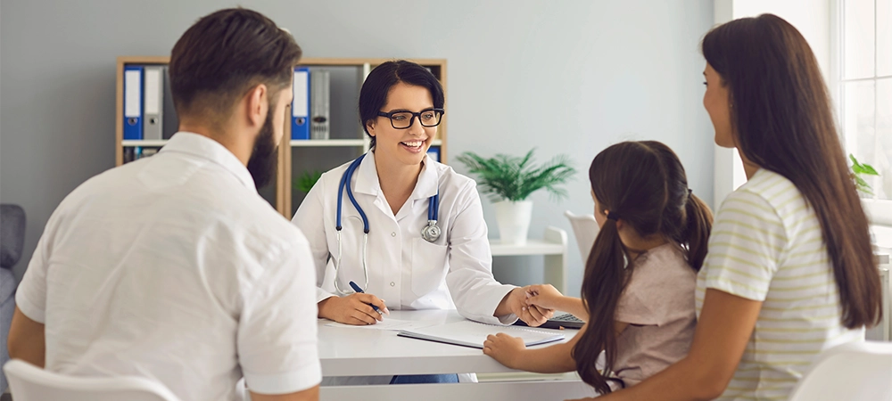 The family doctor smiles at the patients in the clinic.