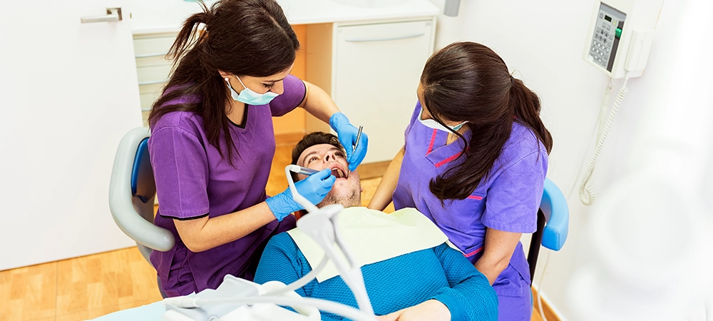 Dentists during a dental intervention with a patient. Dentist Concept