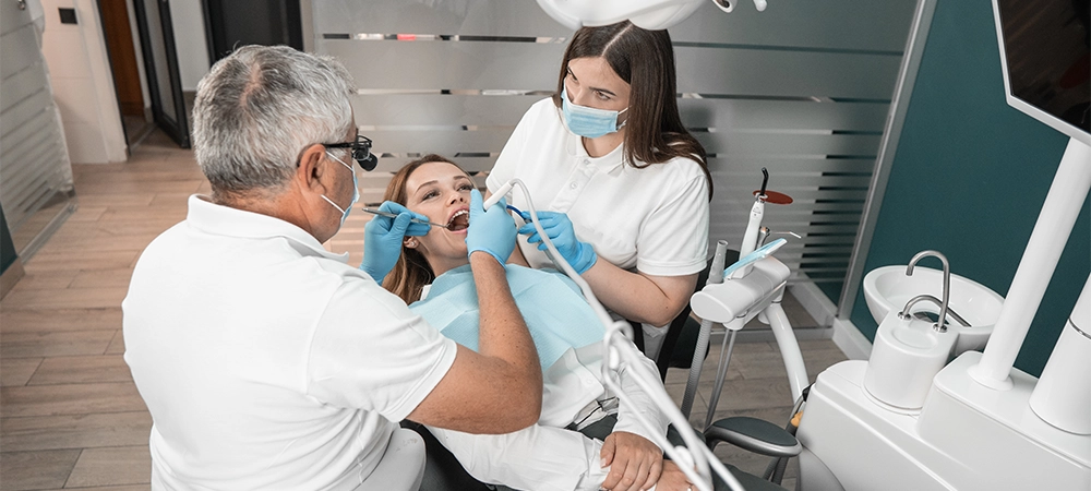 The procedure for installing dental implants is performed with maximum comfort for the patient. A dentist uses modern techniques to treat and restore dental health with a dental assistant.