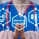 Doctor working on virtual touch screen presses inscription: IMMUNITY BOOSTER. Immunity booster medicine concept. Build Immune System.
