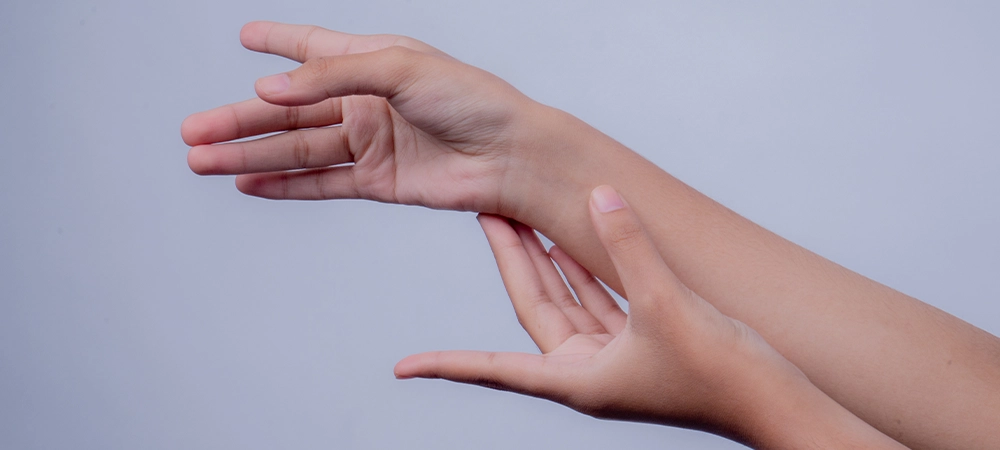 A delicate interaction of hands against a clean, diffused background, evoking concepts of touch, sensitivity, and care, perfect for conveying messages of wellness and connection.